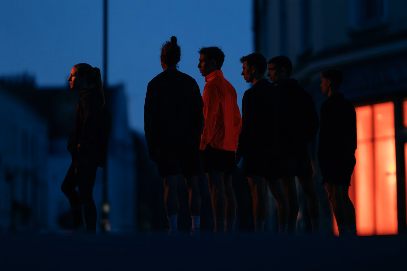 A chapter standing together on a city street at dusk